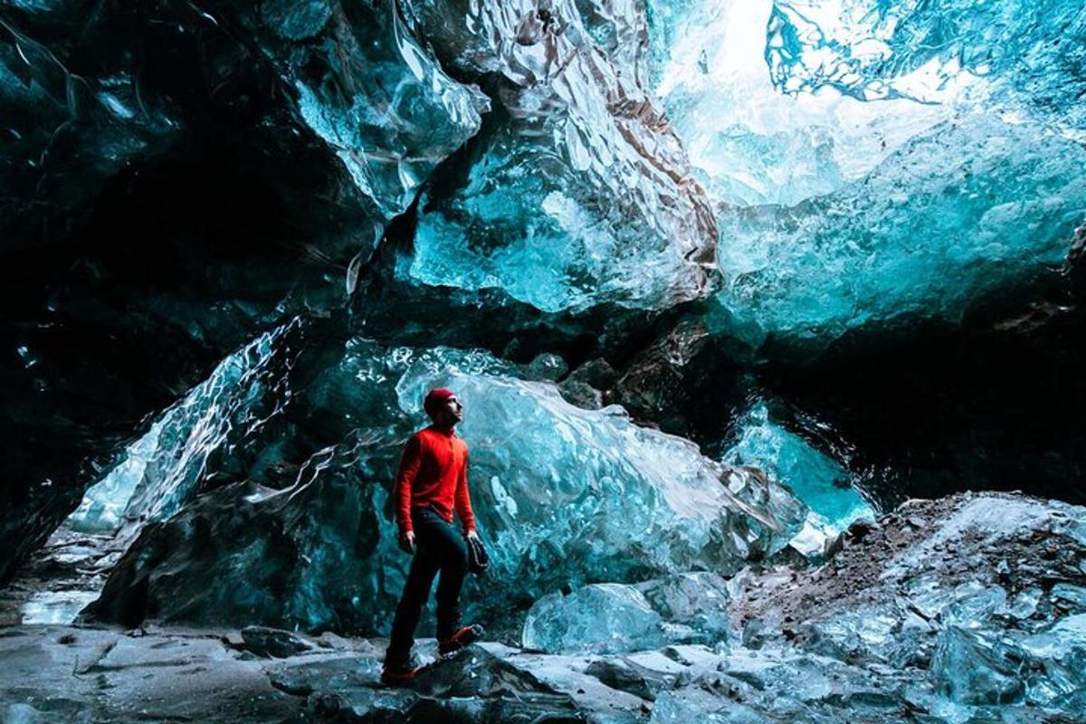 a person standing in front of an ice cave