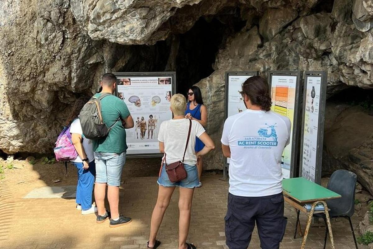 a group of people looking at a sign in a cave