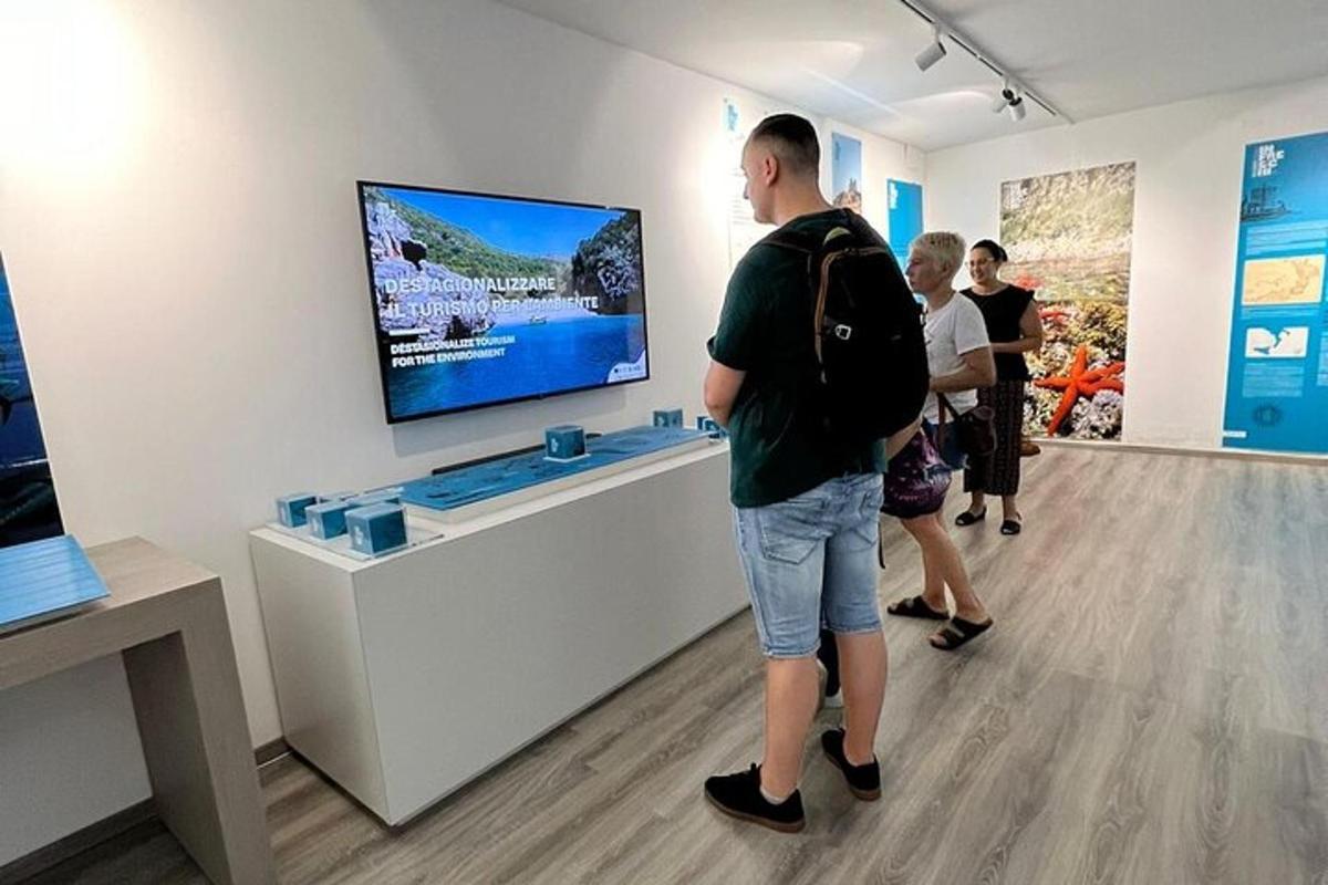 a group of people looking at a display in a museum