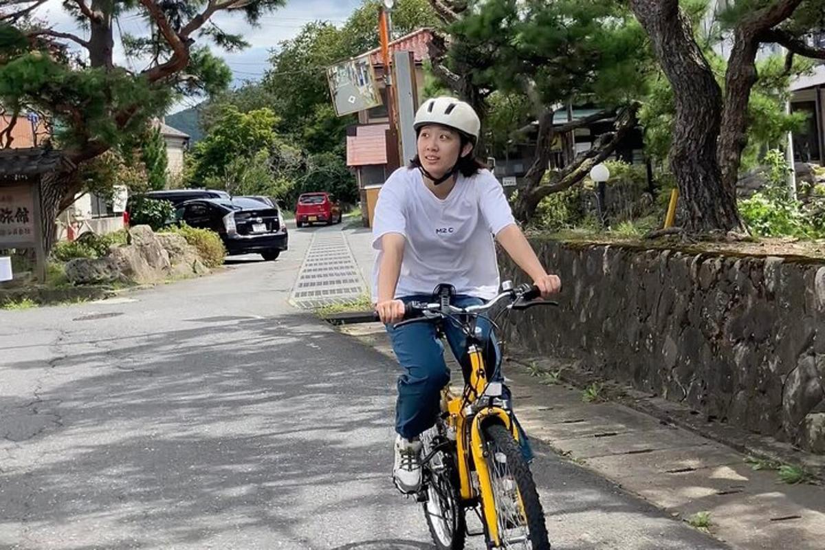 a young girl riding a bike down a street