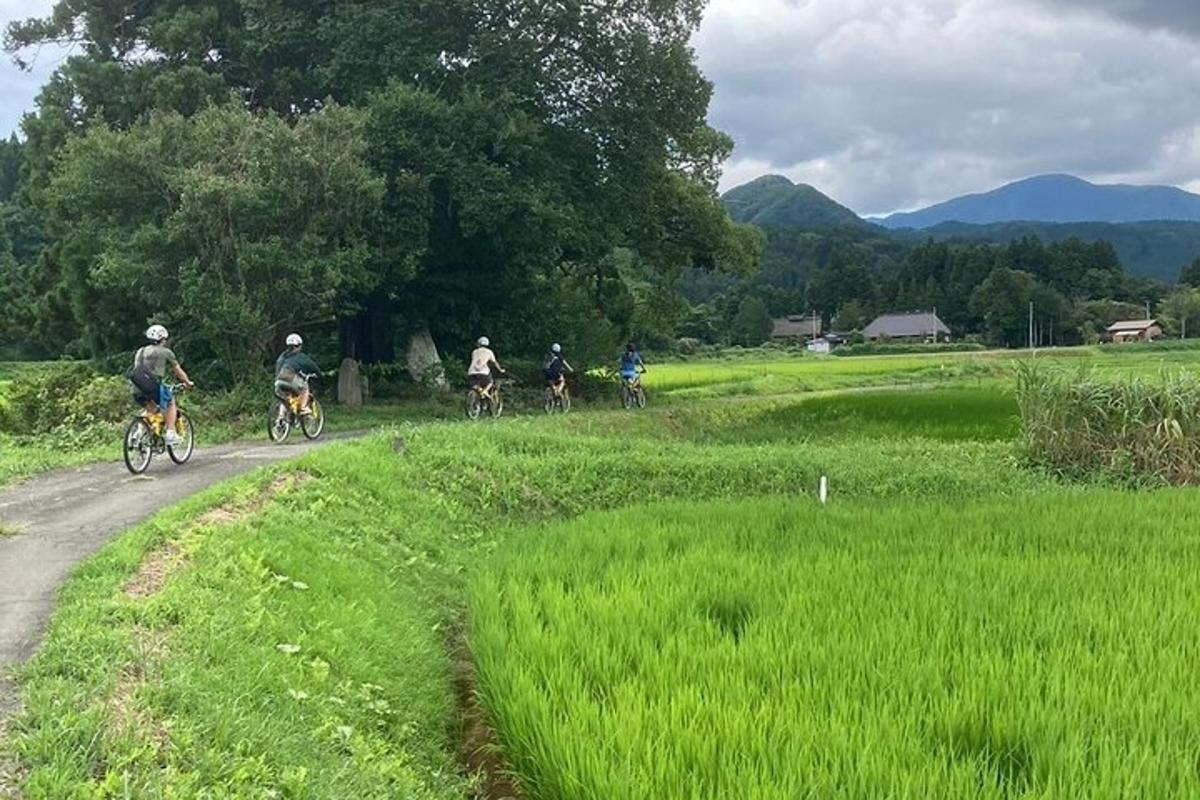 a group of people riding bikes down a dirt road