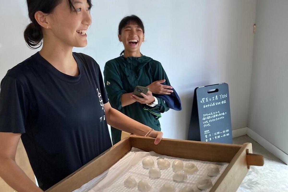 two women standing next to a box of cookies