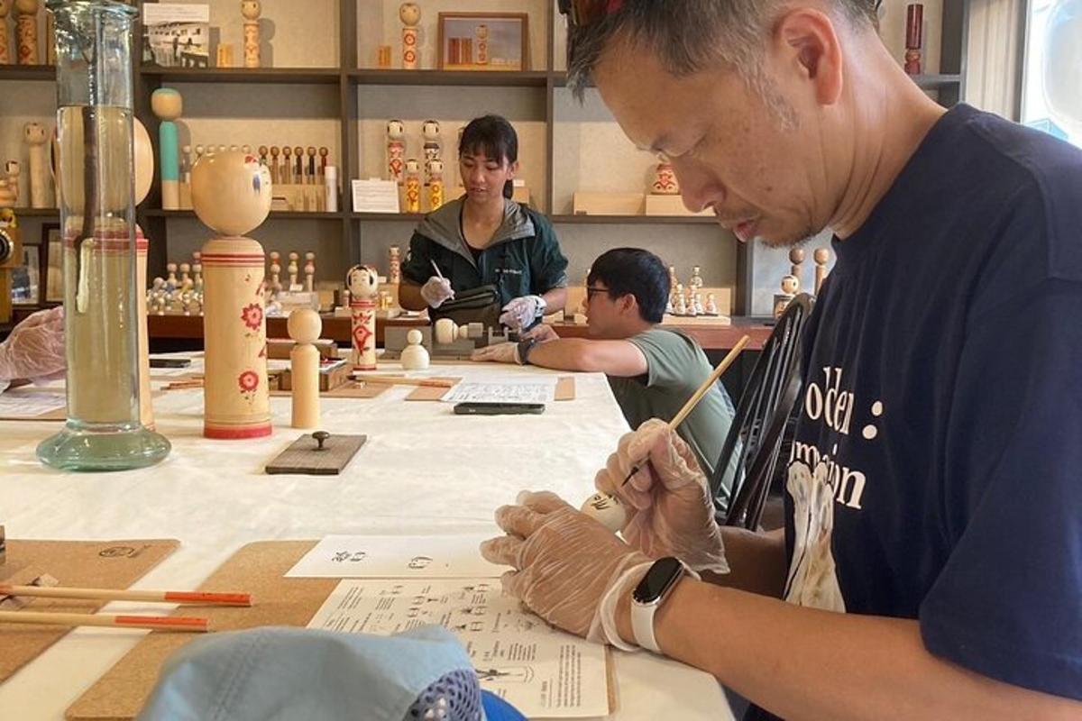 a man sitting at a table working on a piece of paper