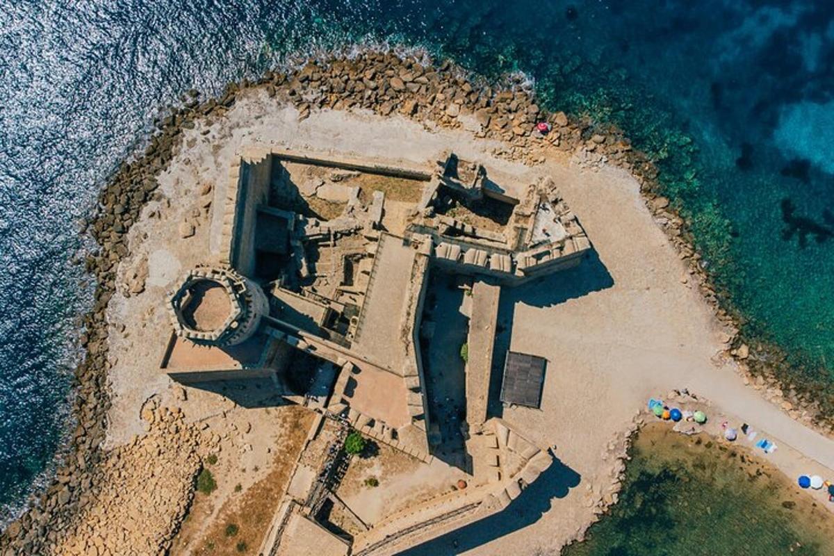 an aerial view of a castle on an island in the ocean