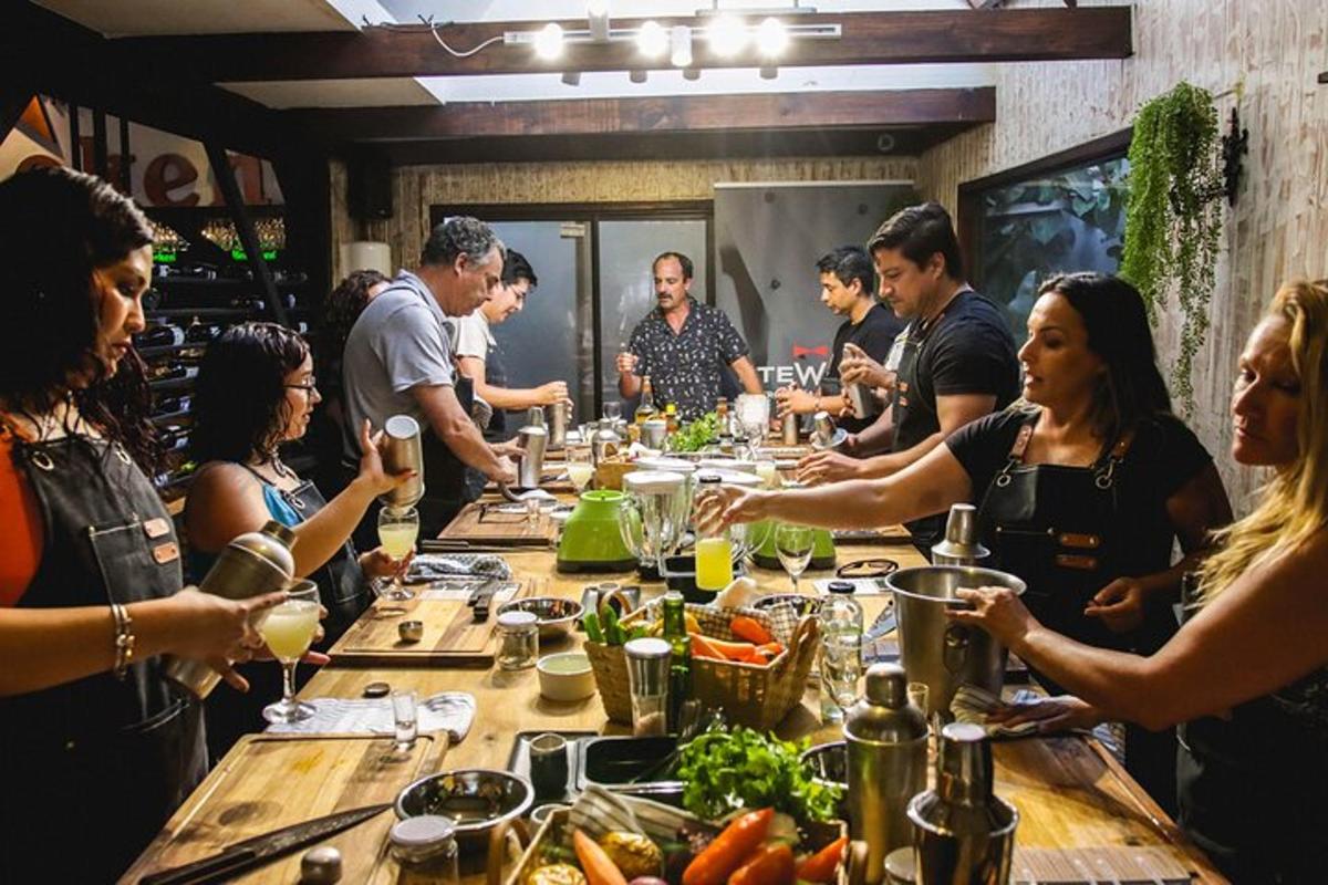 a group of people standing around a table with food