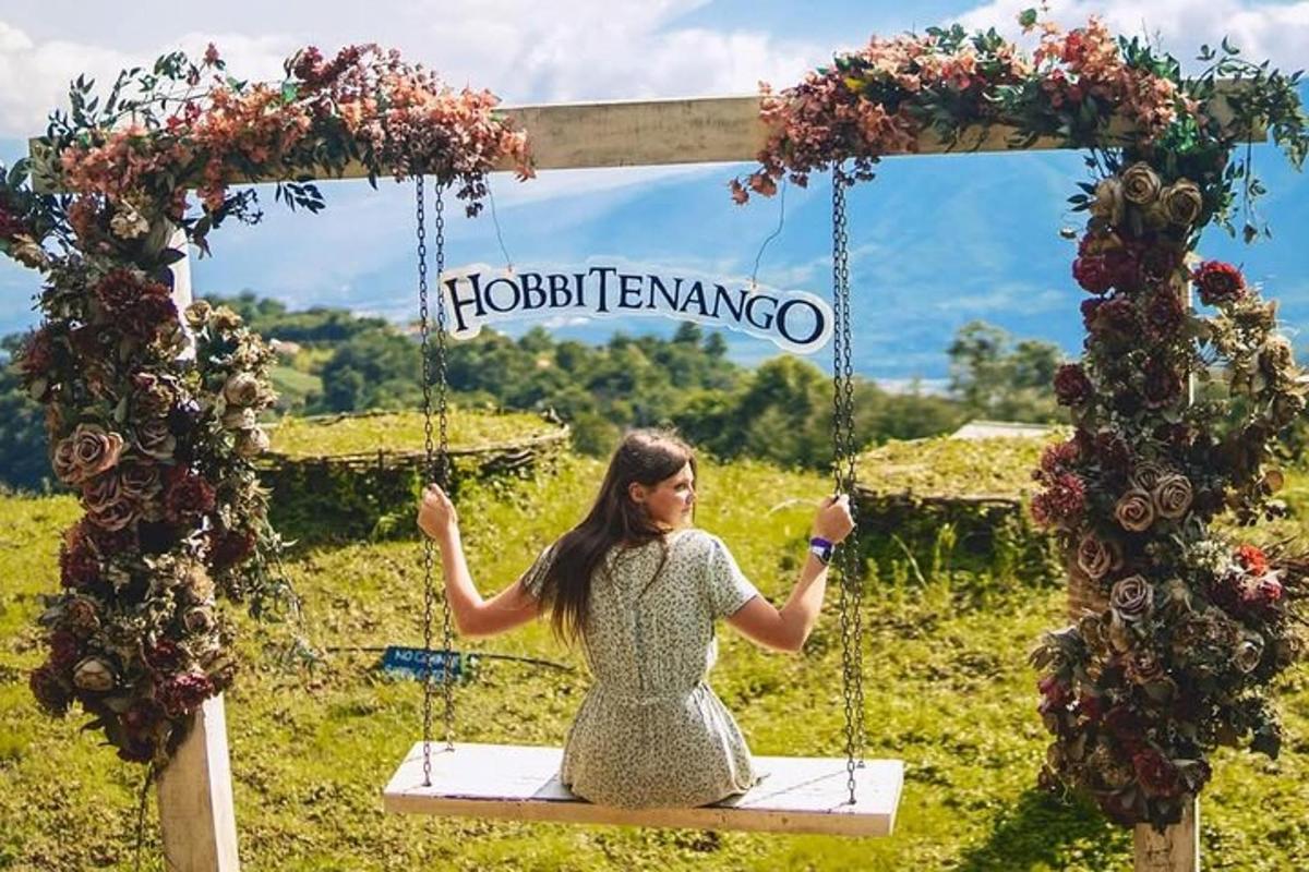 a woman sitting on a swing with flowers