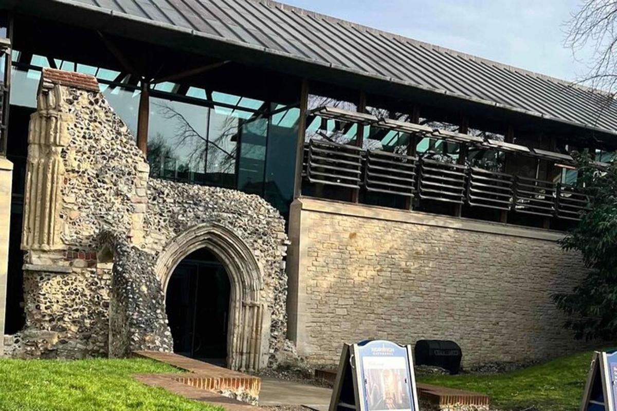 an old stone building with a roof and a gate