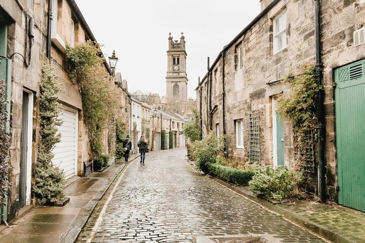 a person walking down a cobblestone street with a clock tower
