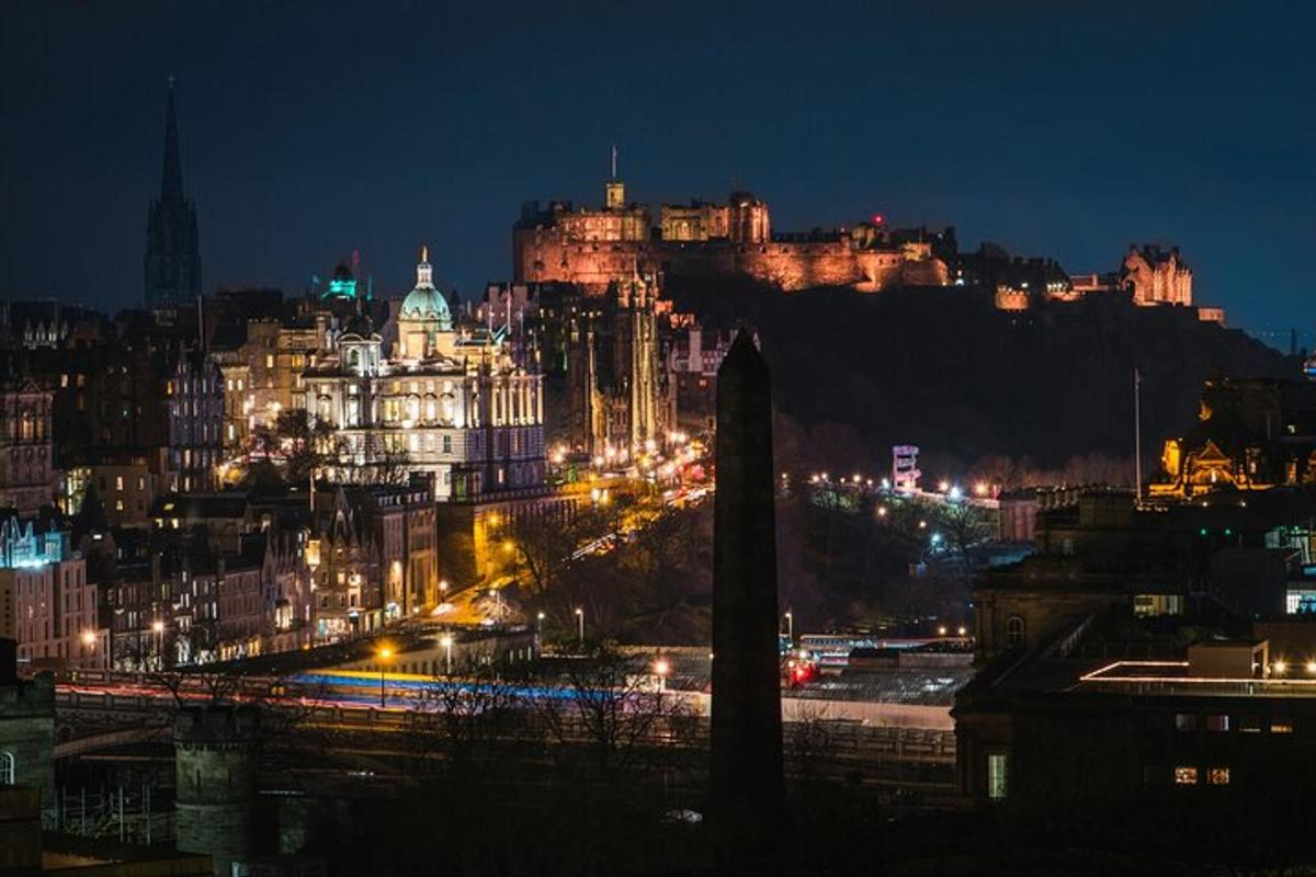 a view of a city at night with a castle
