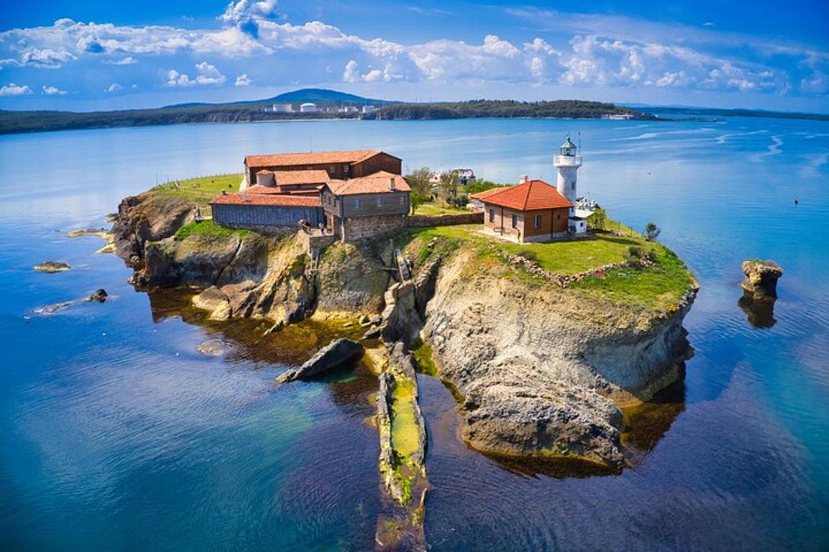 an island with a lighthouse on a body of water