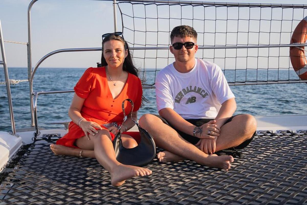 a man and woman sitting on the back of a boat