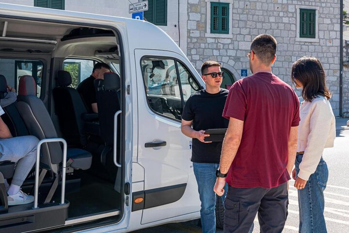 a group of people standing outside of a van