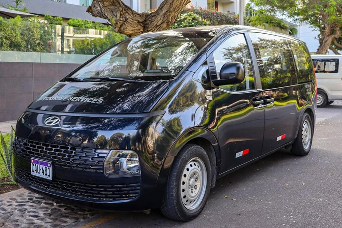 a small black van parked on a city street