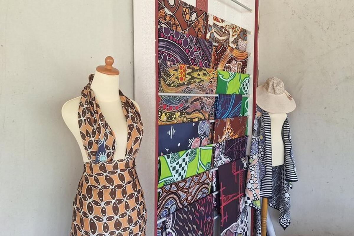 a dress is hanging on a wall next to a display