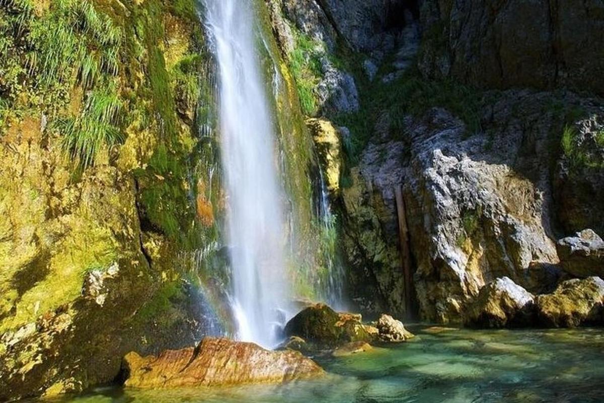 a waterfall on the side of a mountain with water