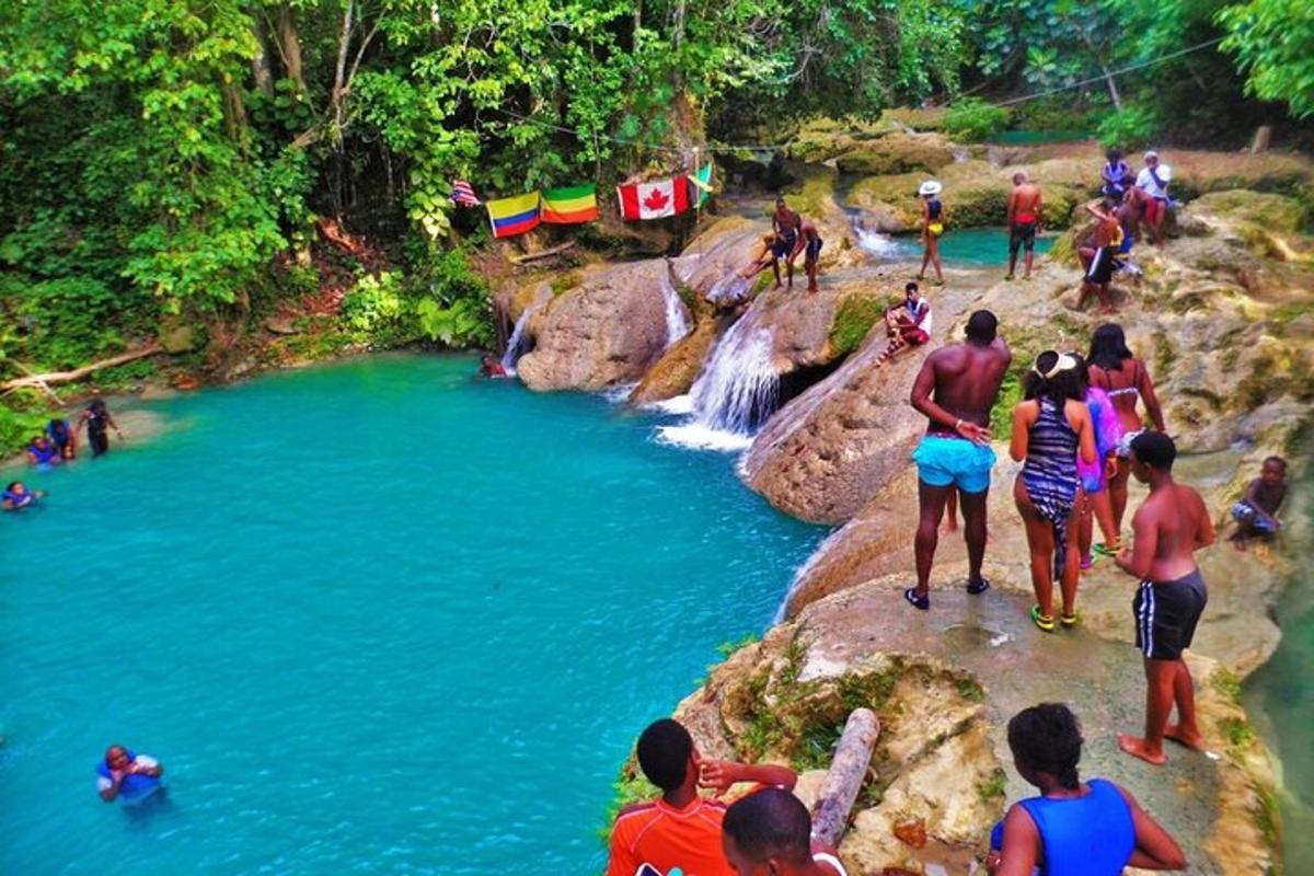 a group of people standing on rocks near a river