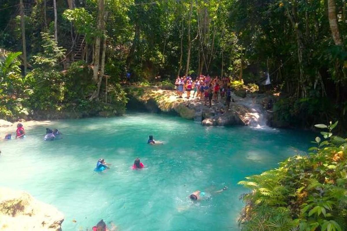 a group of people swimming in a blue river