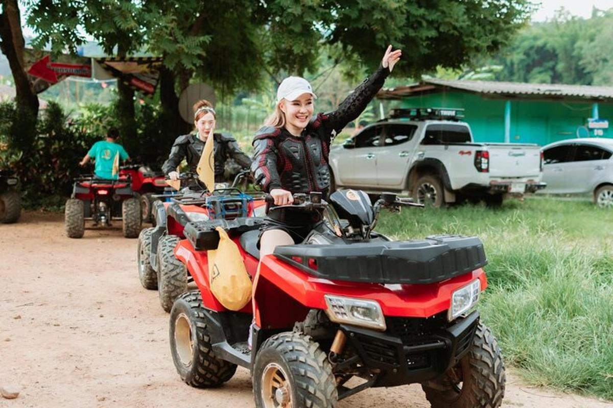 two people riding atvs on a dirt road