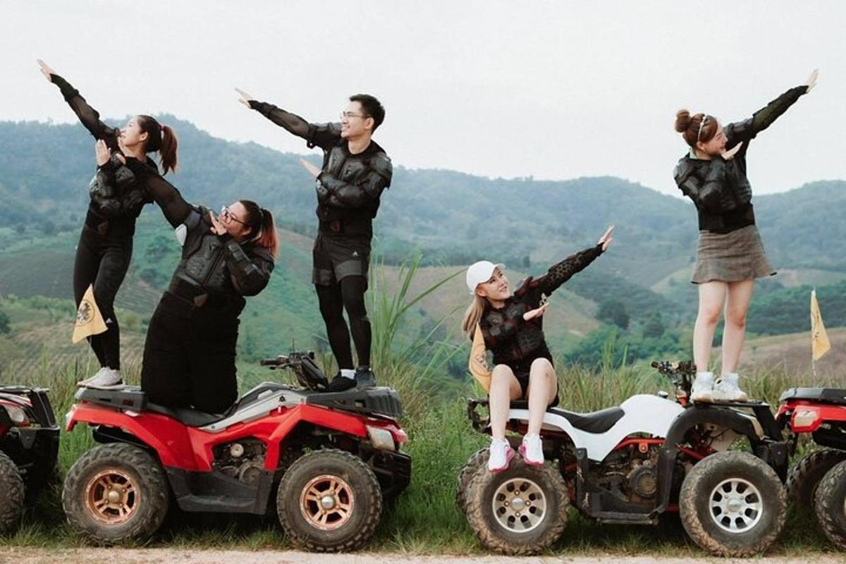 a group of people standing on atvs in a field