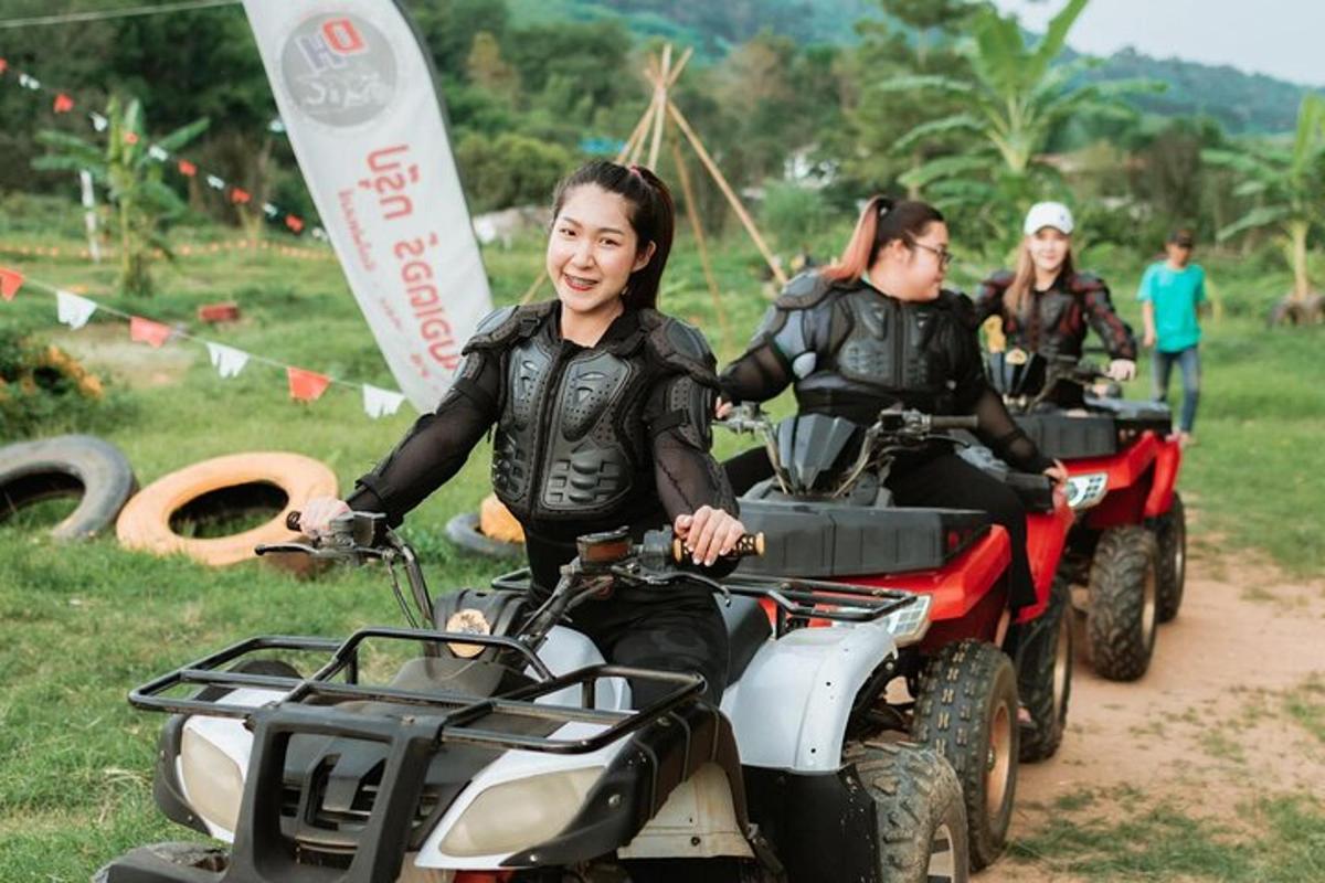 two people riding on atvs on a dirt road