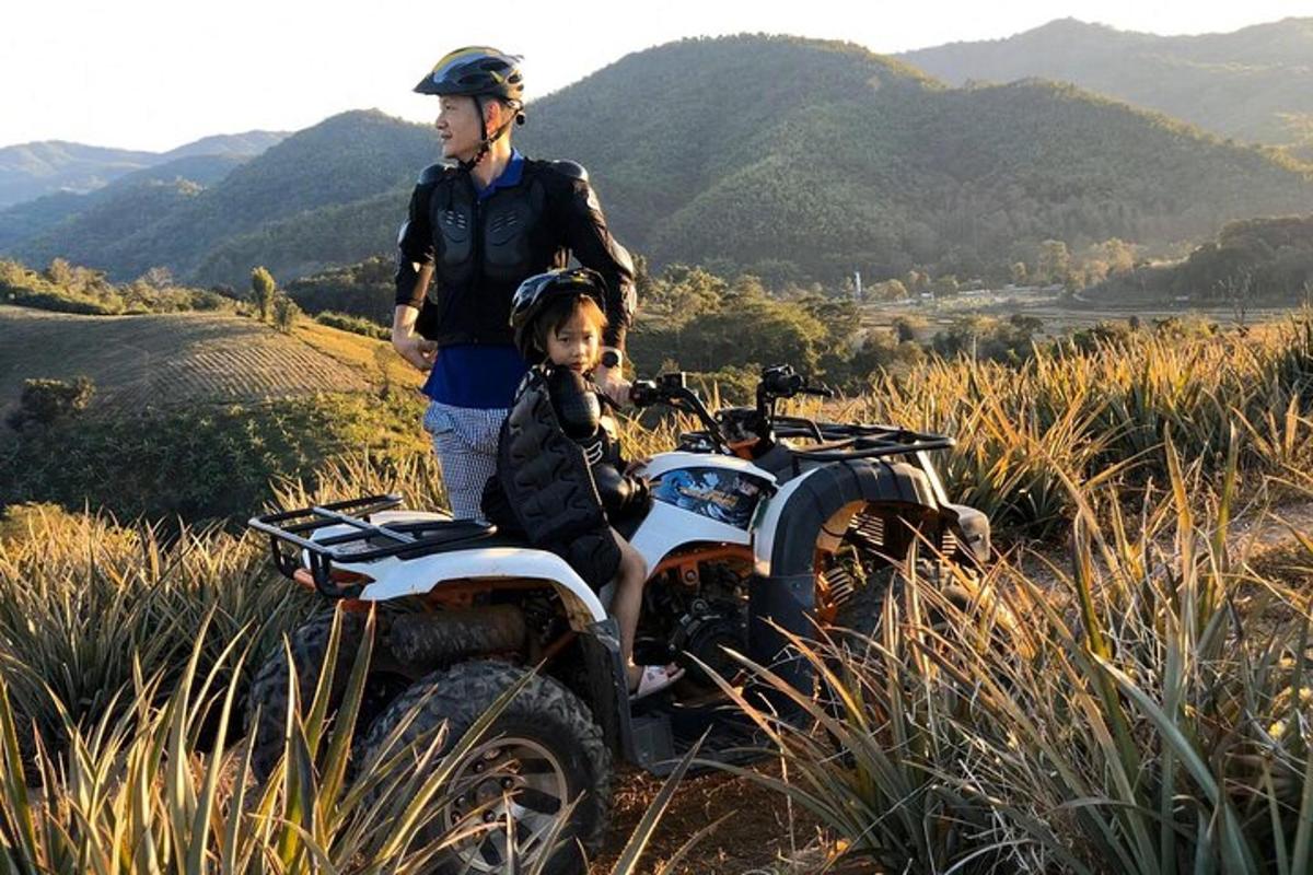 a man and a child sitting on a dirt bike