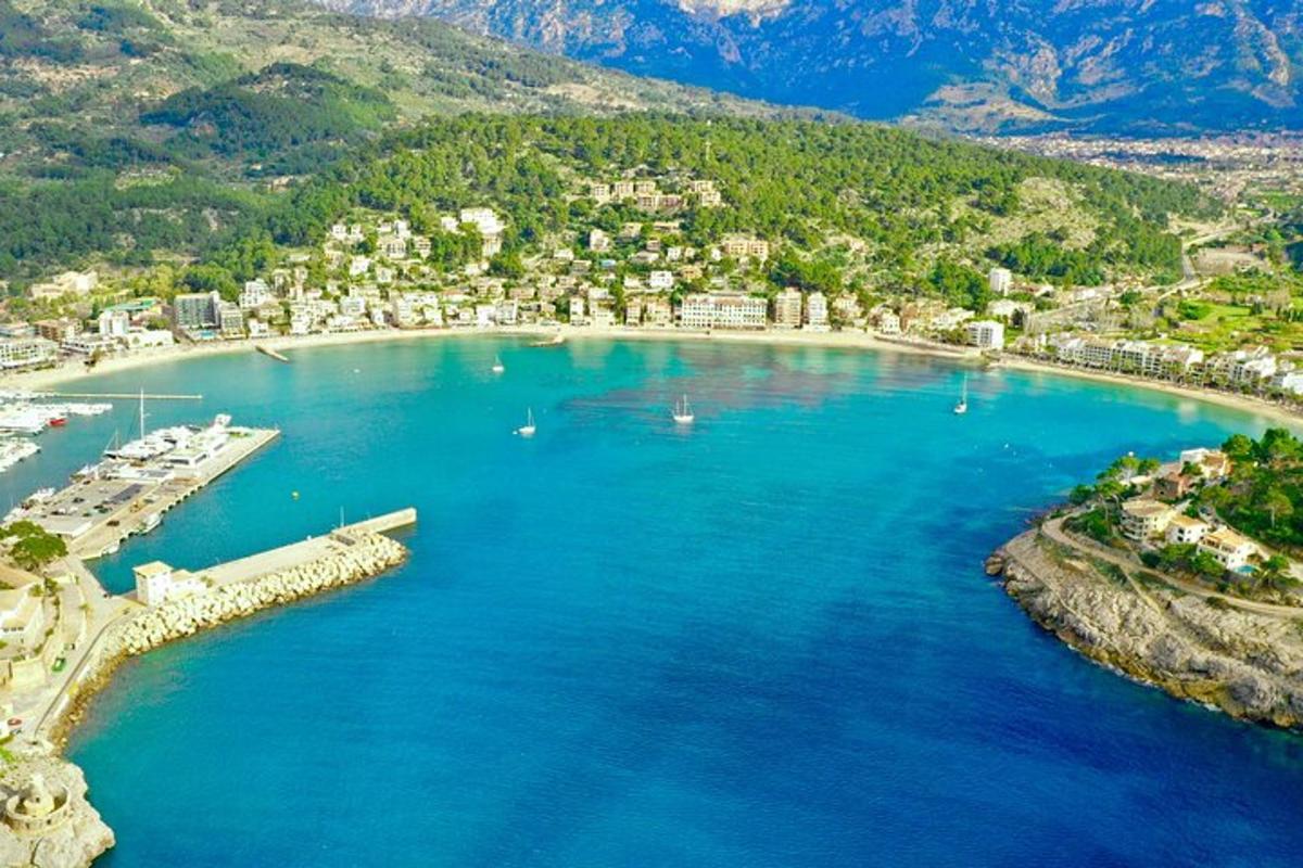 an aerial view of a beach with boats in the water
