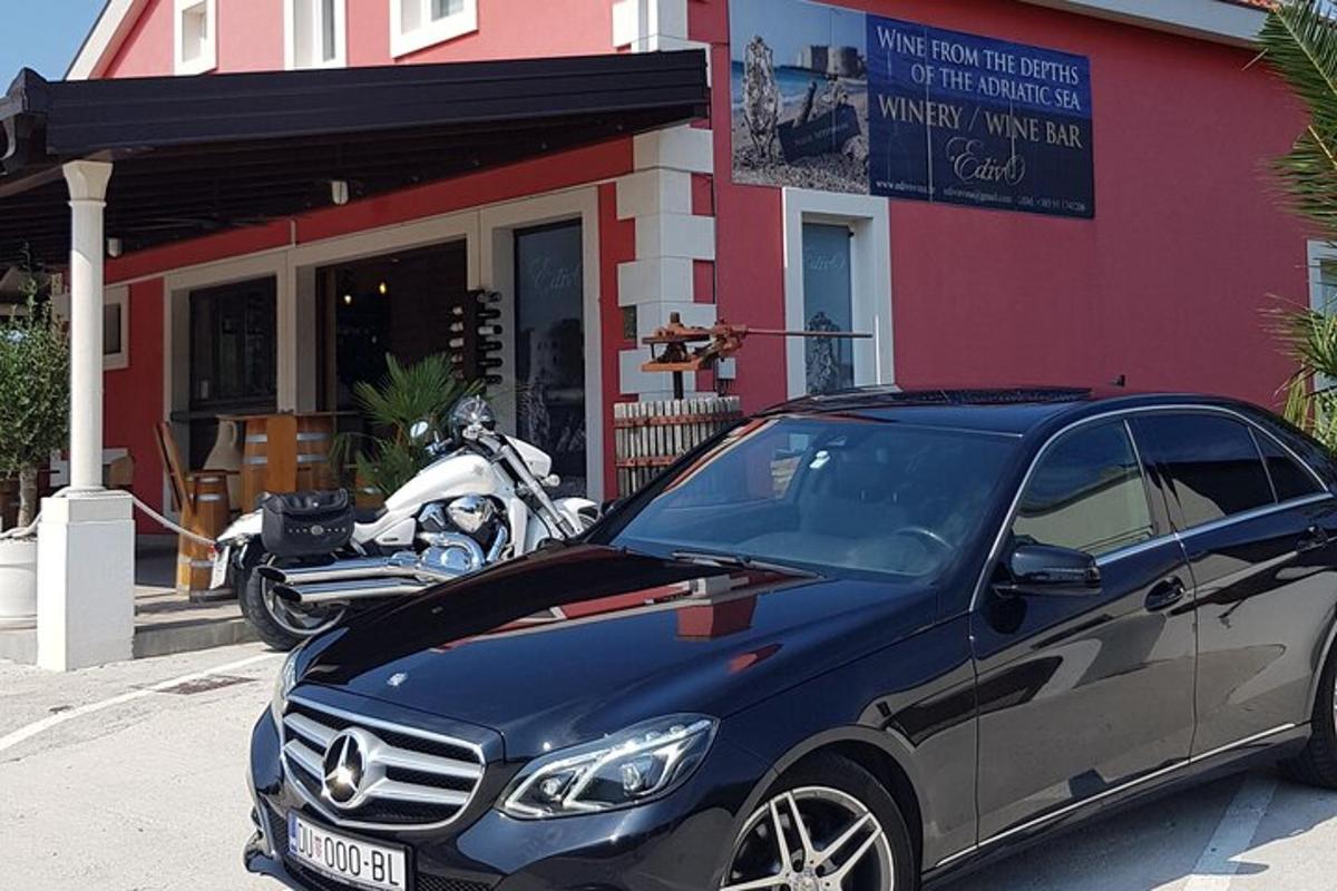 a car parked in front of a building with motorcycles