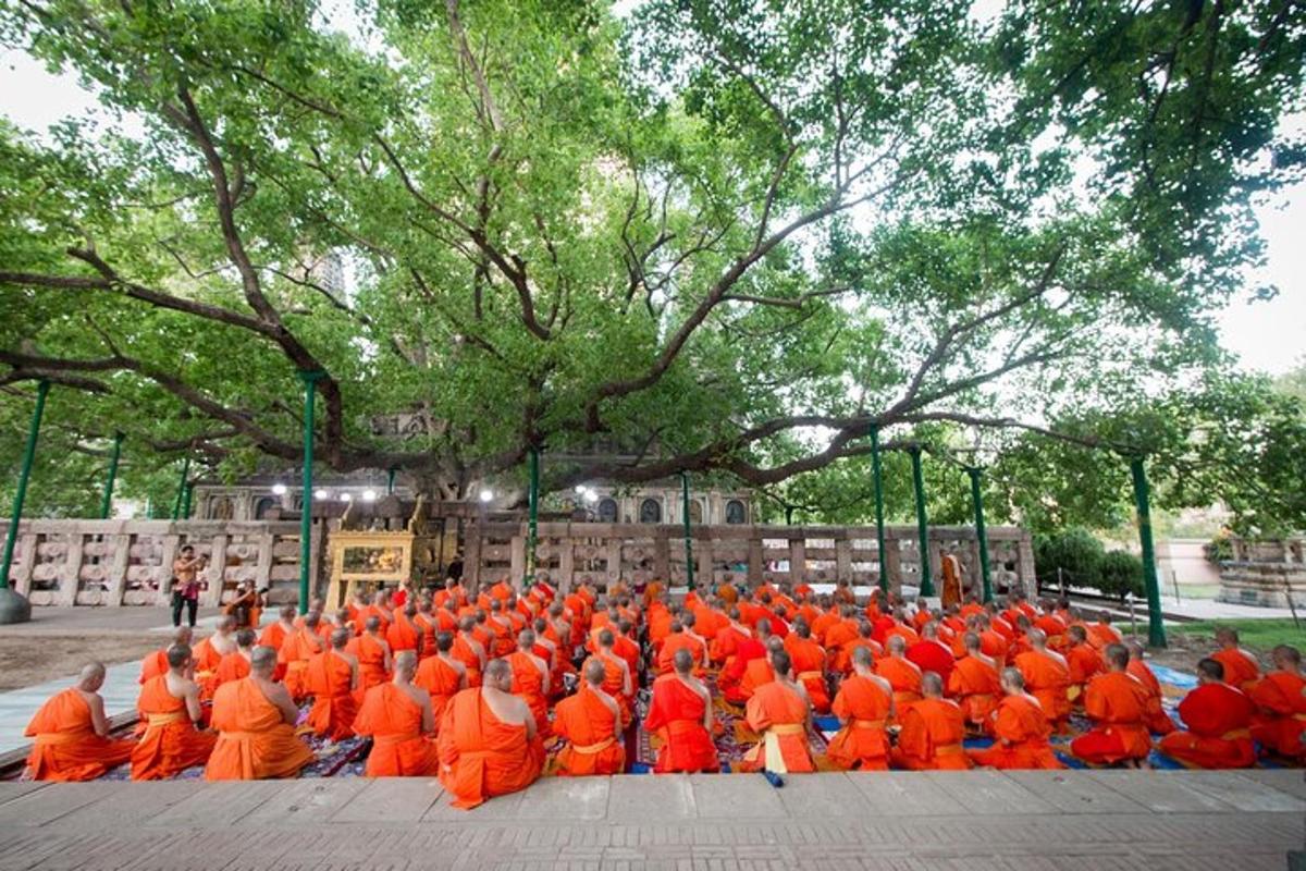 a group of people in orange uniforms sitting on the ground