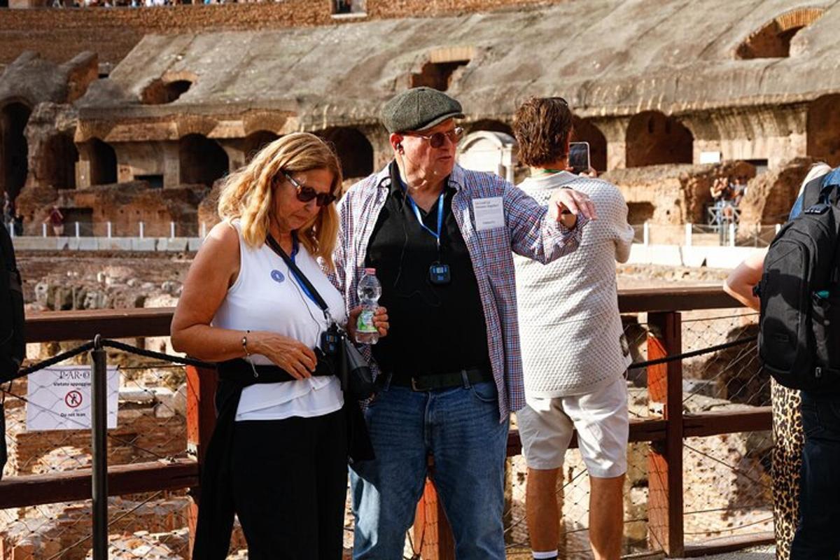 a man and a woman standing in front of the coliseum