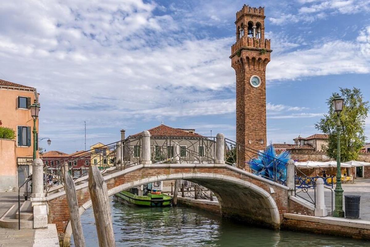 a bridge over a river with a clock tower