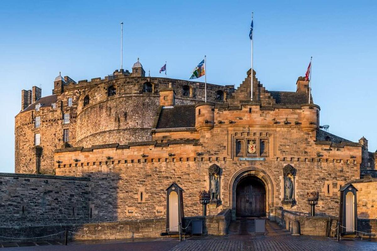 an old castle with two flags on top of it