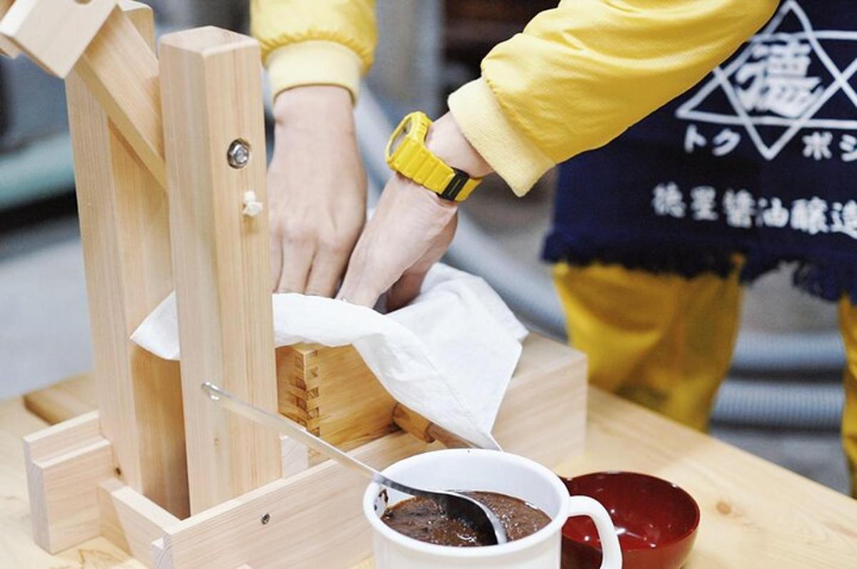 uma pessoa preparando uma xícara de café em uma mesa