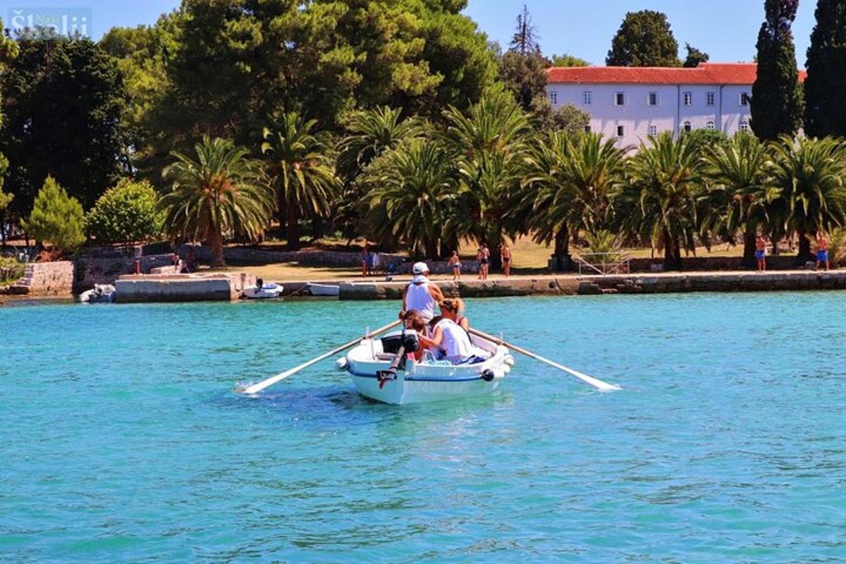 a man and two people in a boat in the water
