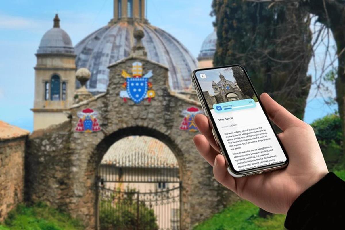 a person holding a cell phone in front of a building