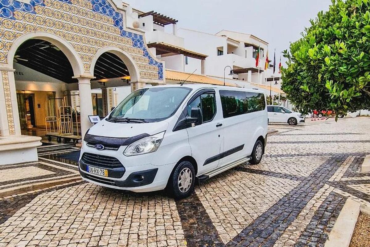 a white van parked in front of a building