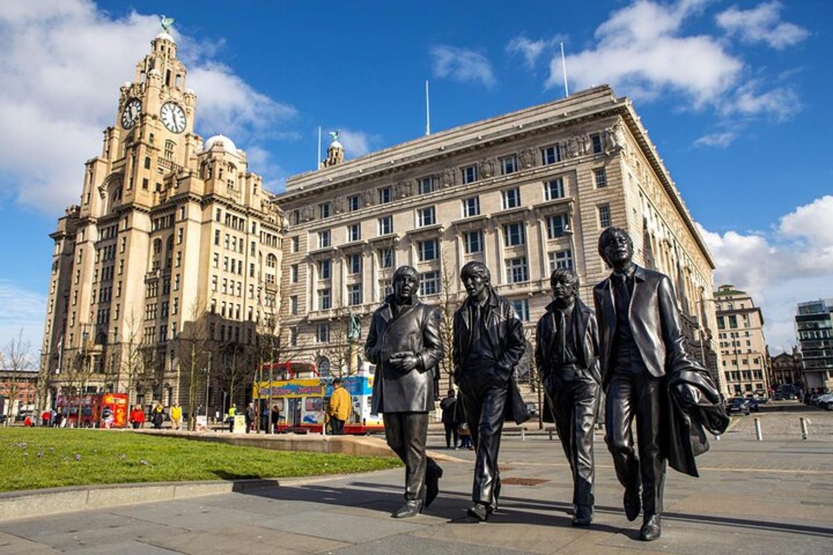 a statue of the beatles in front of a building