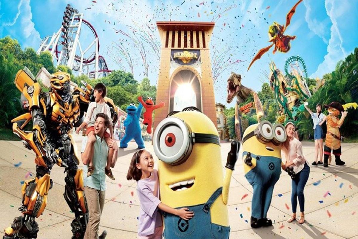 a group of people standing in front of a amusement park