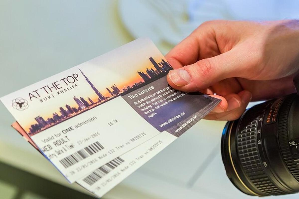 a person holding a ticket and a camera
