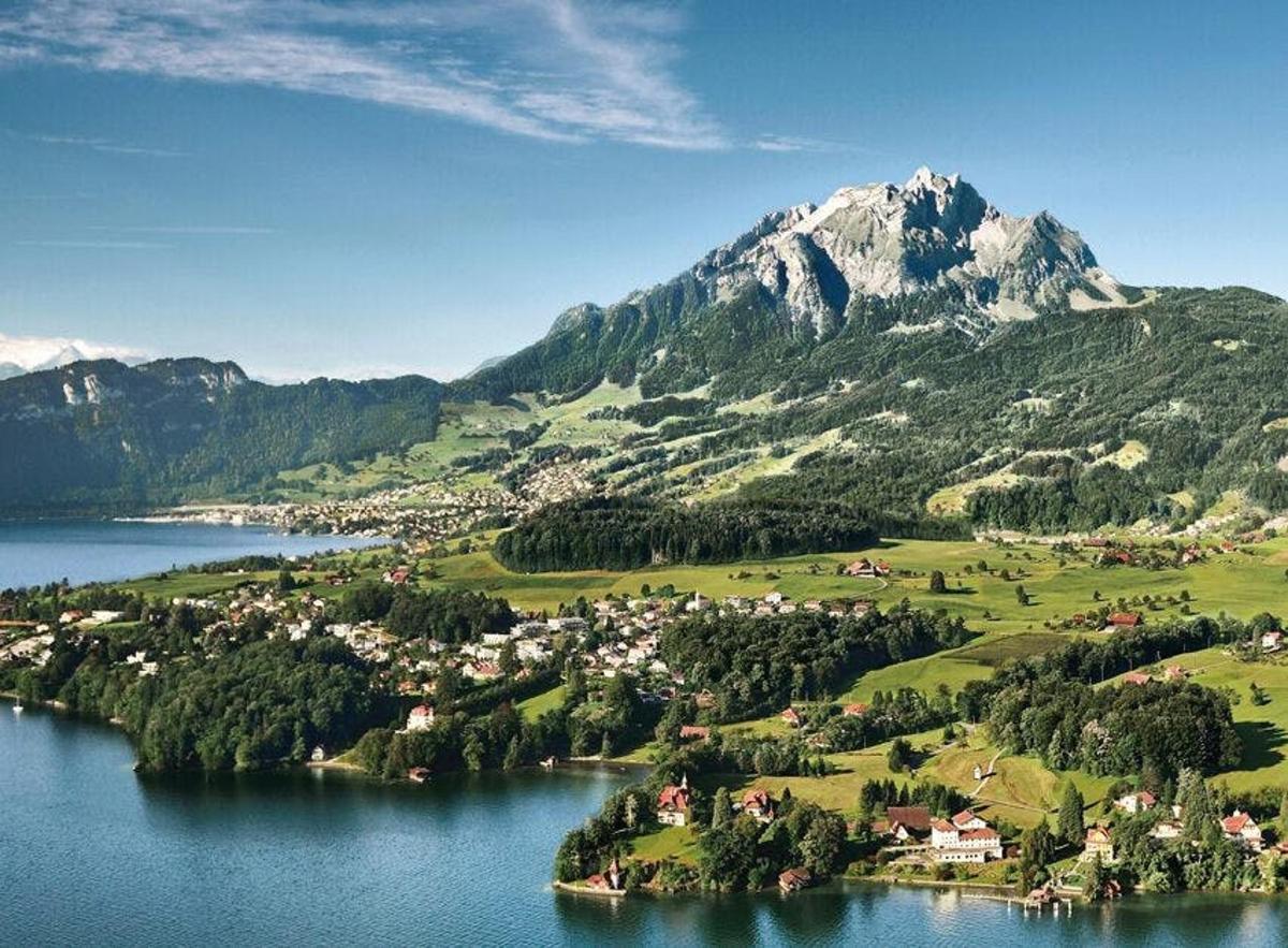 a small town on a lake in front of a mountain