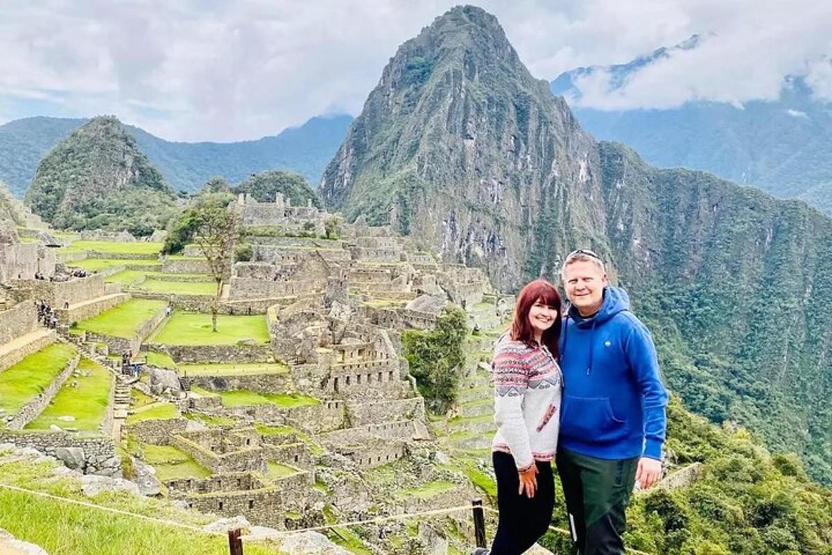 a man and a woman standing on top of a mountain