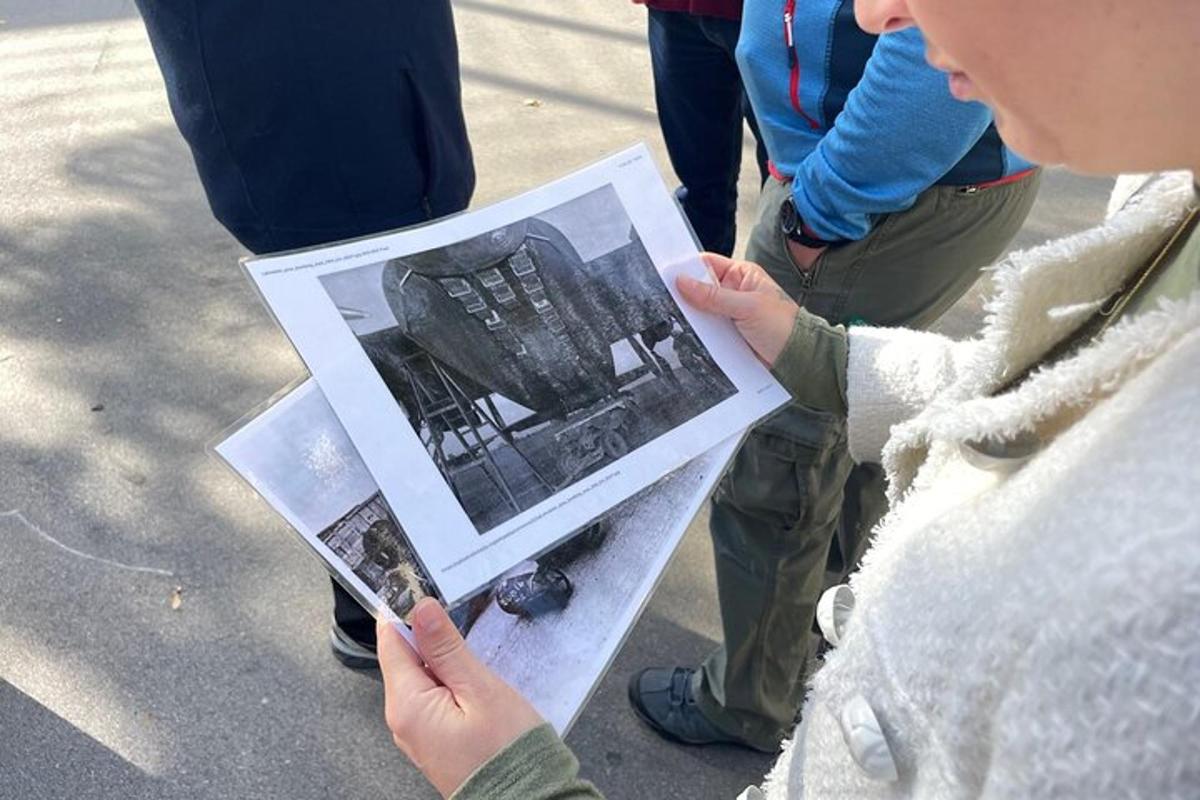 Μια γυναίκα κρατάει μια φωτογραφία ενός κτιρίου