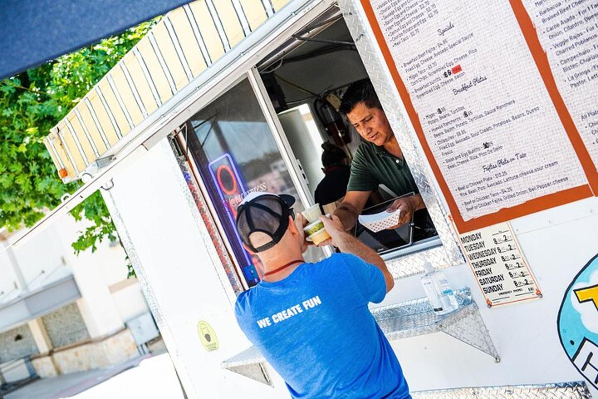 a man standing in the back of a food truck