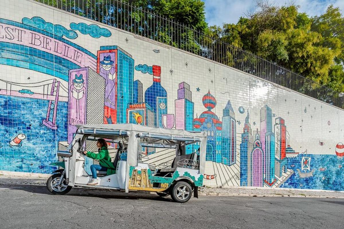 a woman riding a golf cart in front of a mural