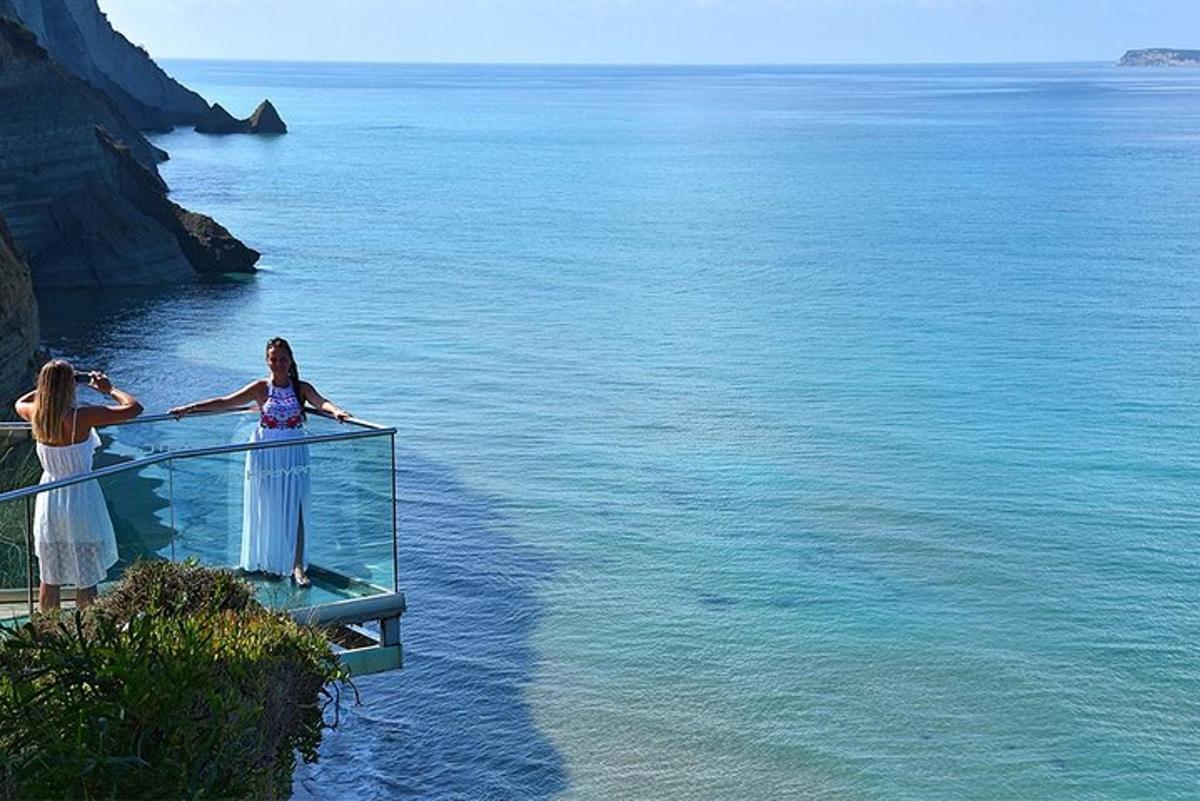 two women standing on a walkway over the water