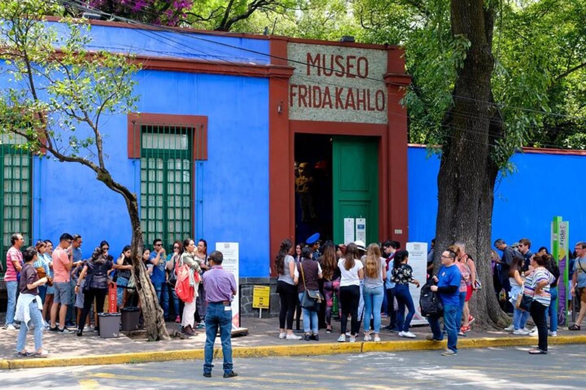 a group of people standing outside of a blue building