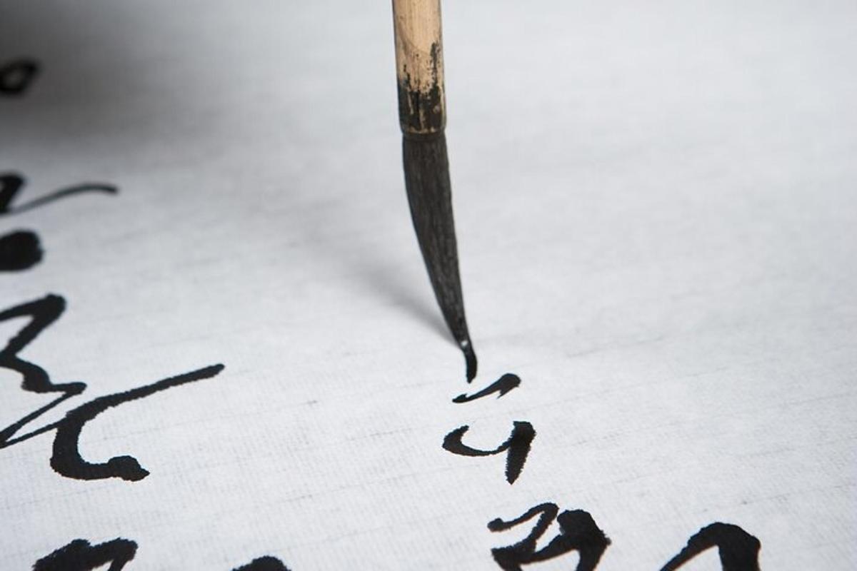 a pen writing on a piece of paper with drawings