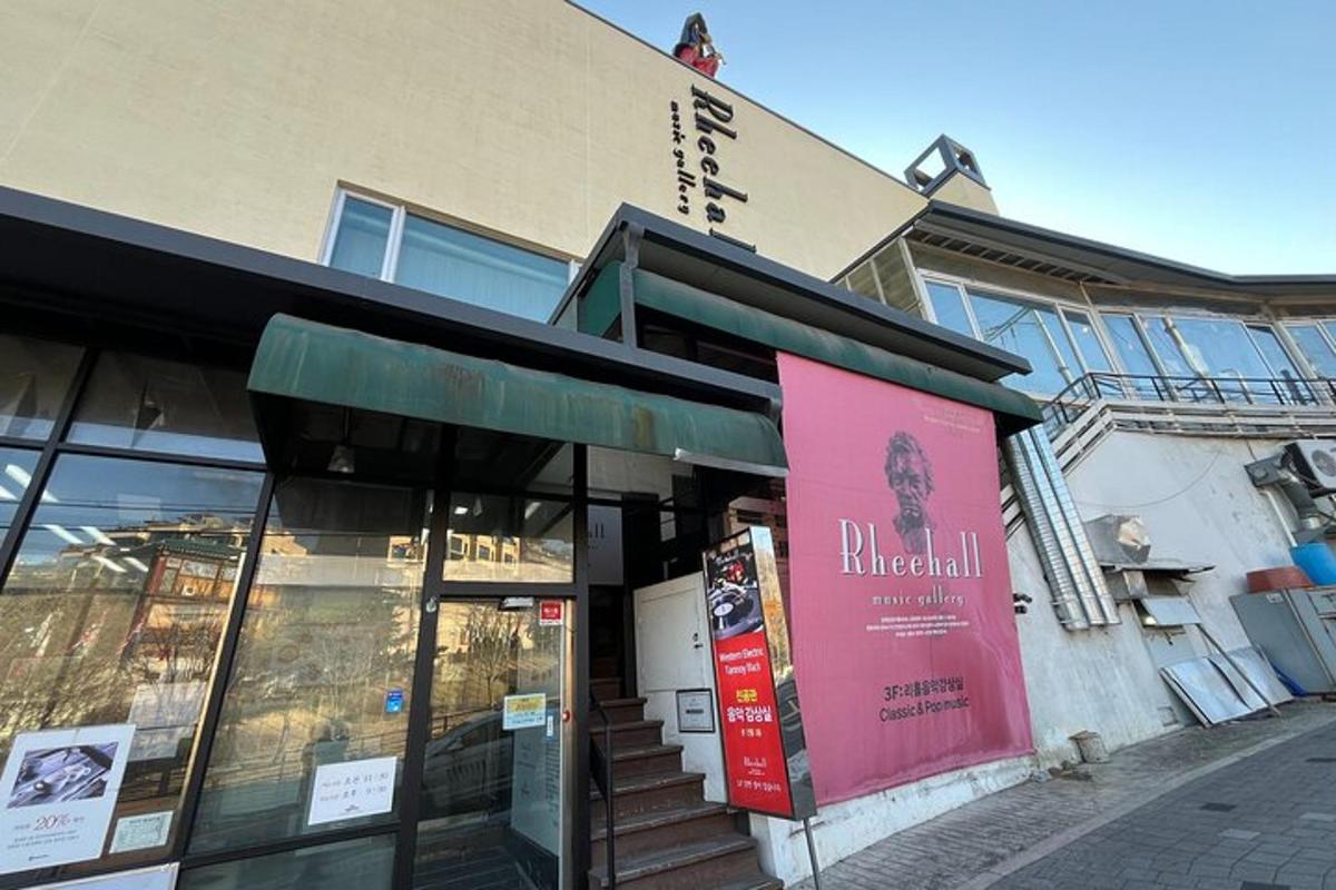 a store with a pink sign in front of a building