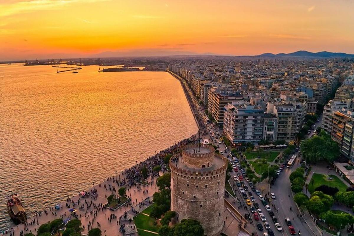 an aerial view of a city with the ocean