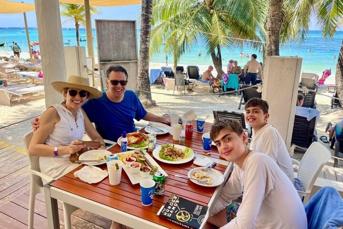 a family eating lunch at a table at the beach
