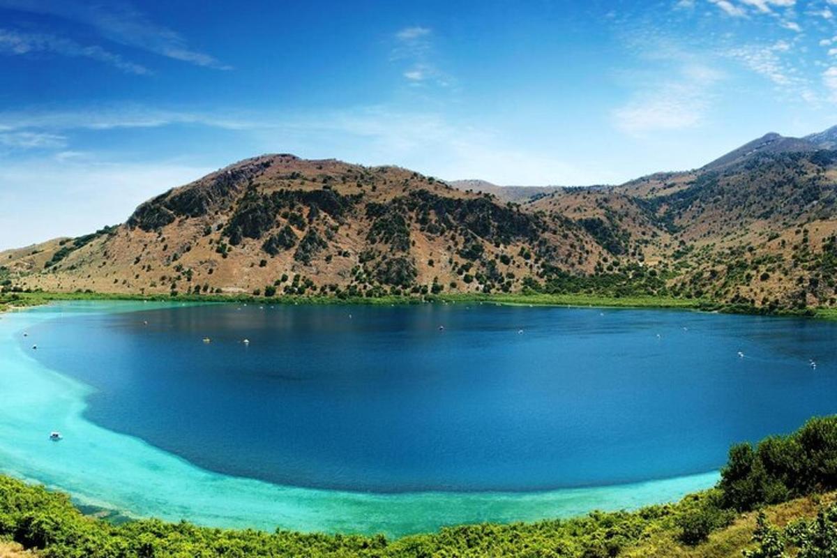 a large blue lake with mountains in the background